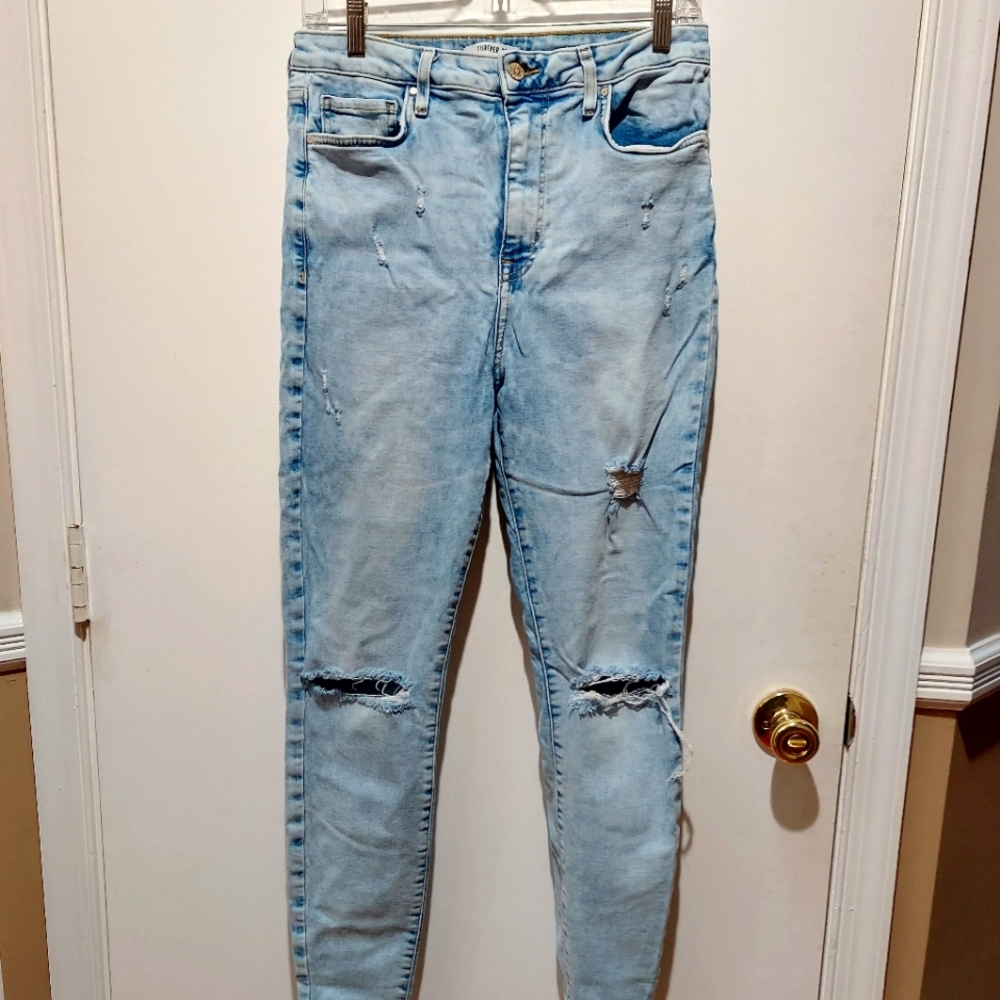 Women's Forever 21 light jeans. Size 30. Ripped throughout.